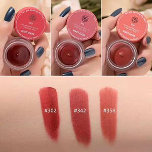 Beauty Glazed Velvet Super Matte Lip & Cheek Mud shades 302, 342, 358 with swatches on skin held by hand with dark blue nails