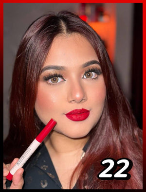 Close-up of a woman with red lipstick holding a matching red lip product, showcasing shade 22 at Pink Flash BD